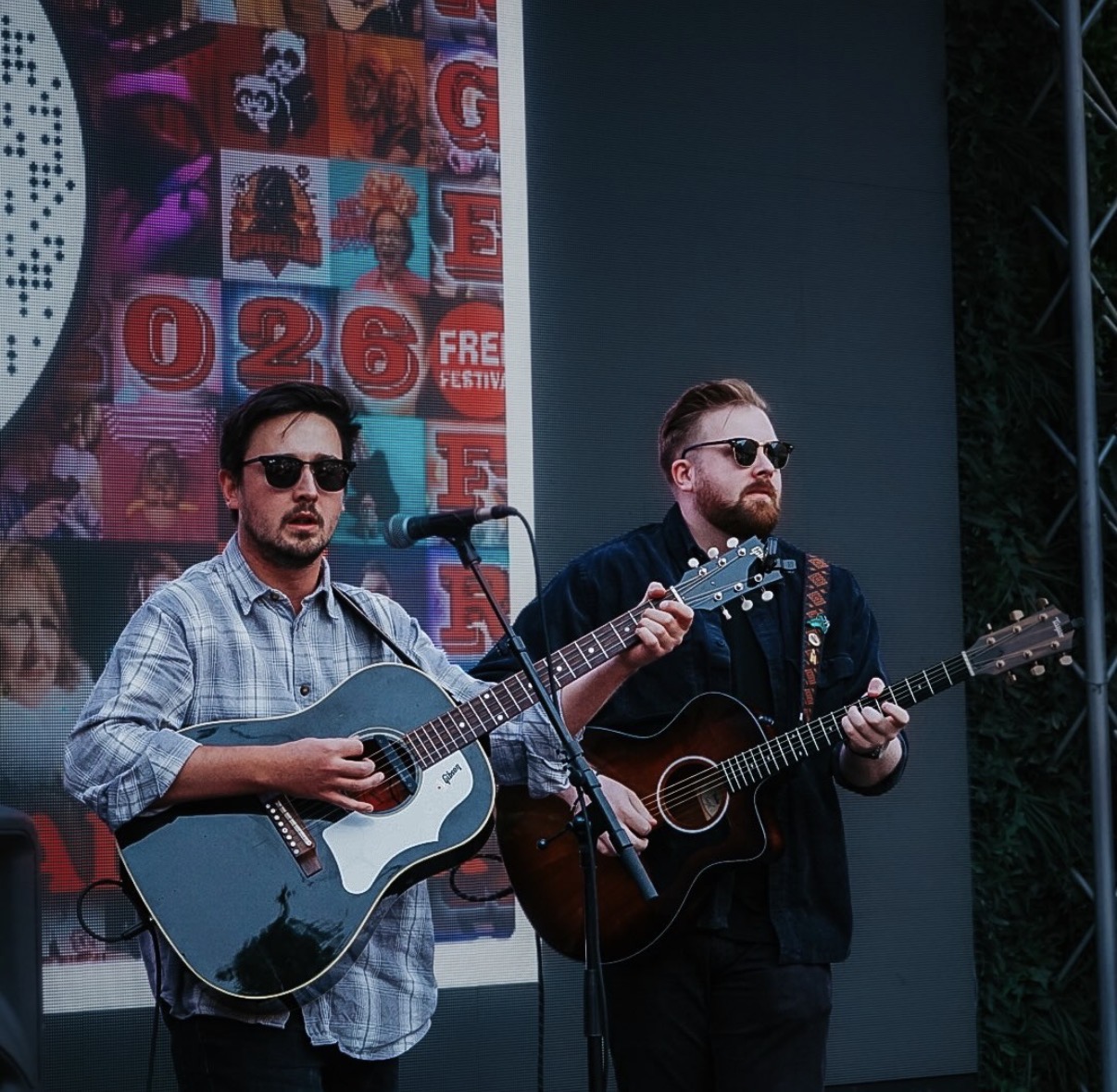 Two acoustic guitarists performing at the Peartree